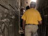 Professor Ashra Kwesi leading the students through the stairs and corridor of the temple of Dendara. The Medu Neter is written all over the pathway to the top of the temple. 