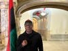 Bashir Muhammad Ptah Akinyele is a teacher, writer, community activist, and Muslim standing next to the Black Liberation Flag. 