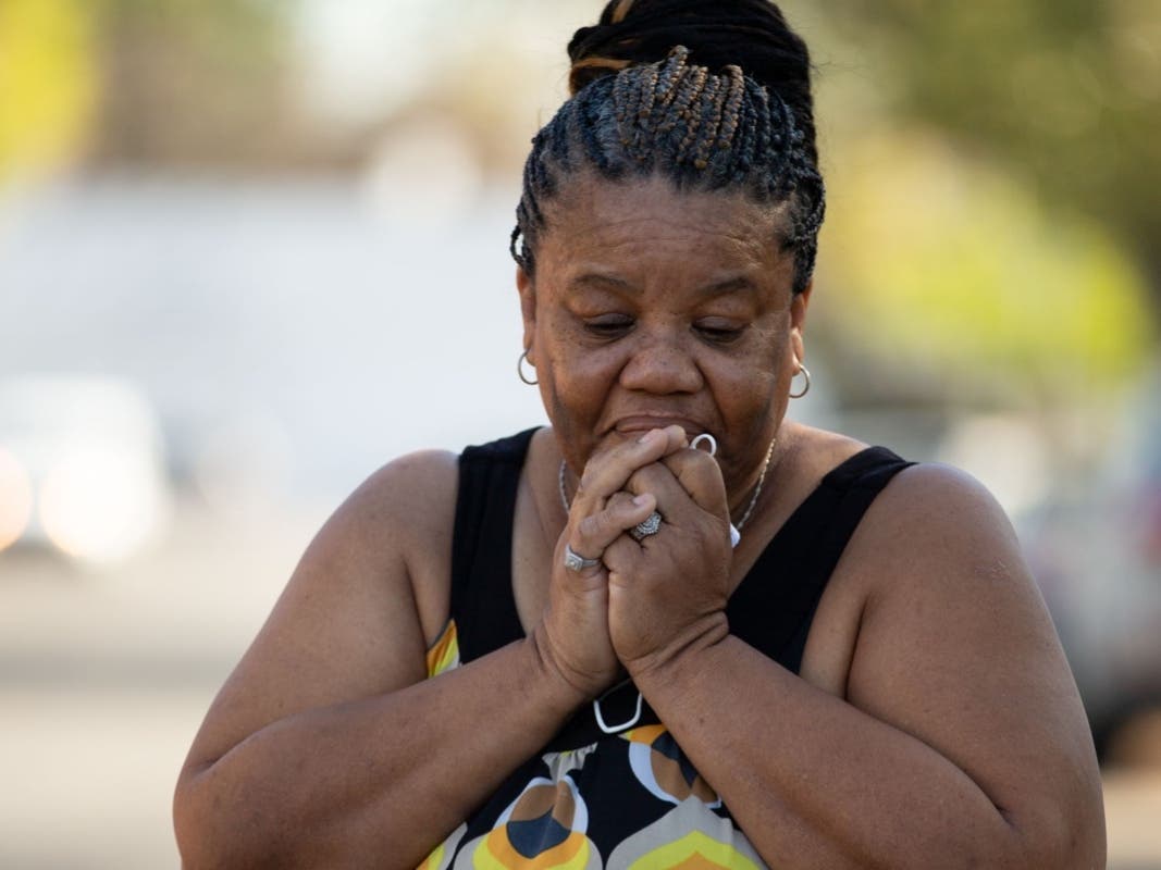 Deborah Bell-Holt stands outside of her home in Jefferson Park near Downtown Los Angeles on Jan. 21, 2021. Having fallen deeper into utilities debt as she took in family and friends during the pandemic, Bell-Holt fears her water will be shut off. 
