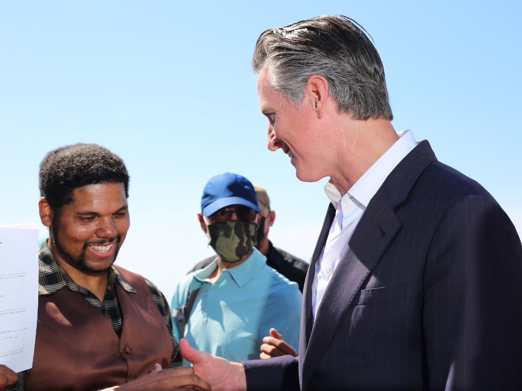 Gov. Gavin Newsom signs a bill to return Bruce's Beach to Anthony Bruce, the great-great grandson of Charles and Willa Bruce, on Sept. 30, 2021. 
