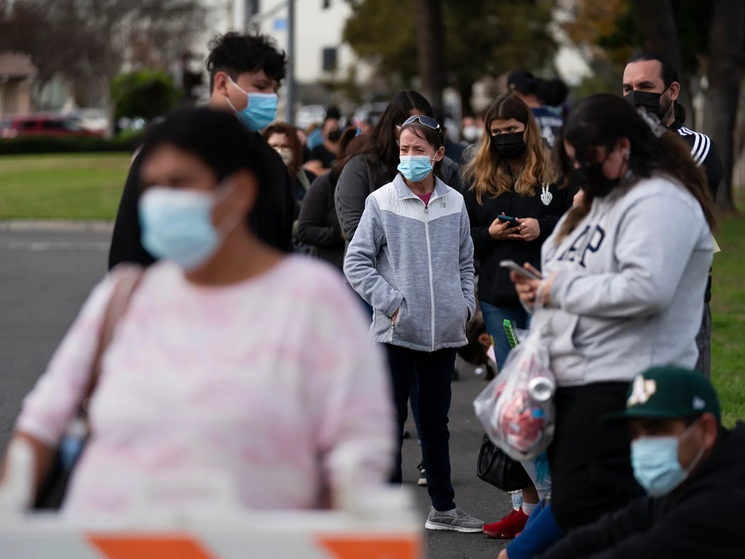 People wait in line for a COVID-19 test at a mobile testing site in Paramount.
