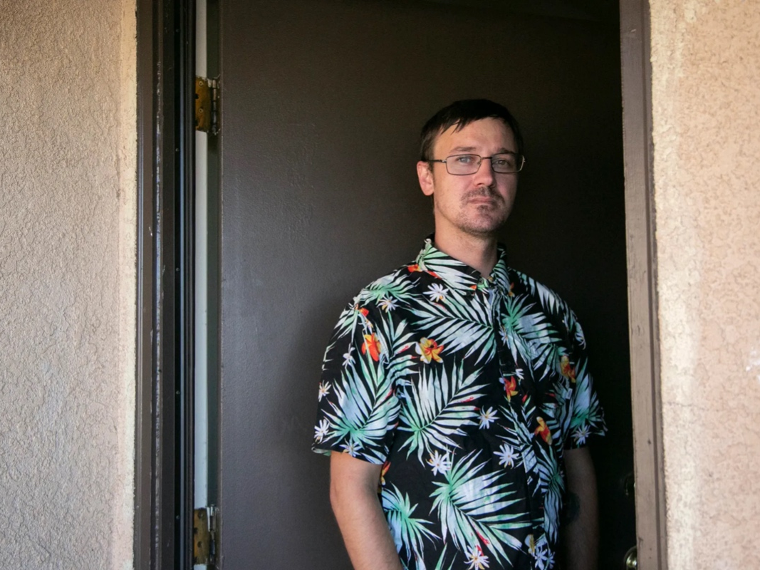 Emergency housing voucher recipient Mitchell Friedeck stands in the entrance to the two-bedroom apartment where he lives with his three children in Nipomo in San Luis Obispo County, on Aug. 2, 2022.