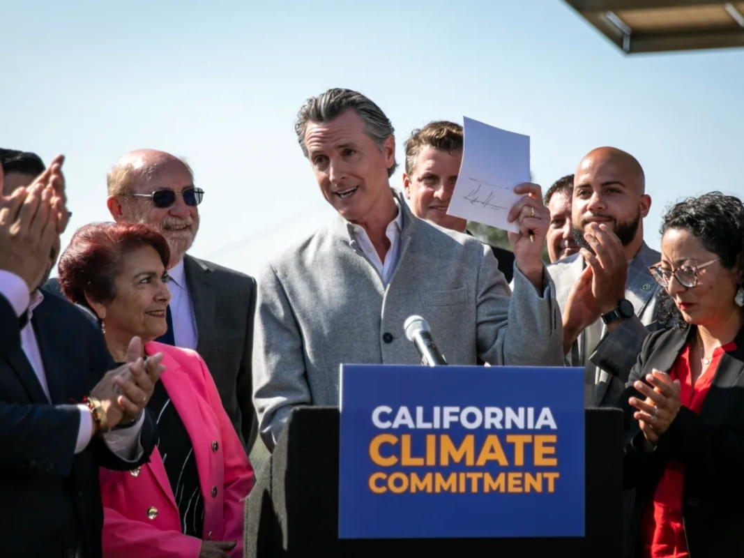 California Gov. Gavin Newsom signs a number of climate-related bills surrounded by state legislators at a press conference at the USDA Forest Service Regional Office on Mare Island in Vallejo on Sept. 16, 2022.