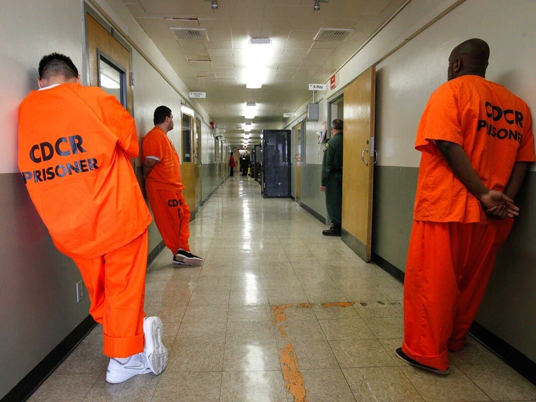 In this 2012 Associated Press file photo, inmates wait for treatment in the infirmary at Deuel Vocational Institute in Tracy. Gov. Gavin Newsom's administration closed the prison in 2021, the first of several that could be shut down.