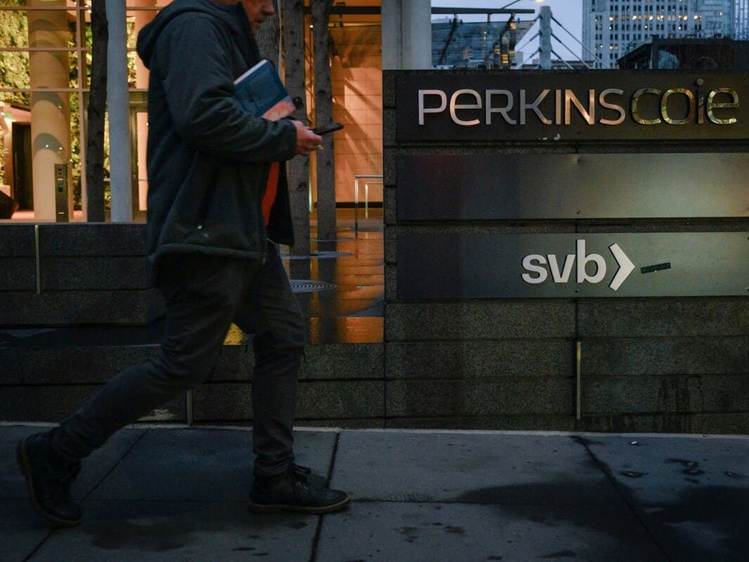 A person walks past the Silicon Valley Bank branch office in downtown San Francisco on March 13, 2023. Photo by Kori Suzuki, Reuters