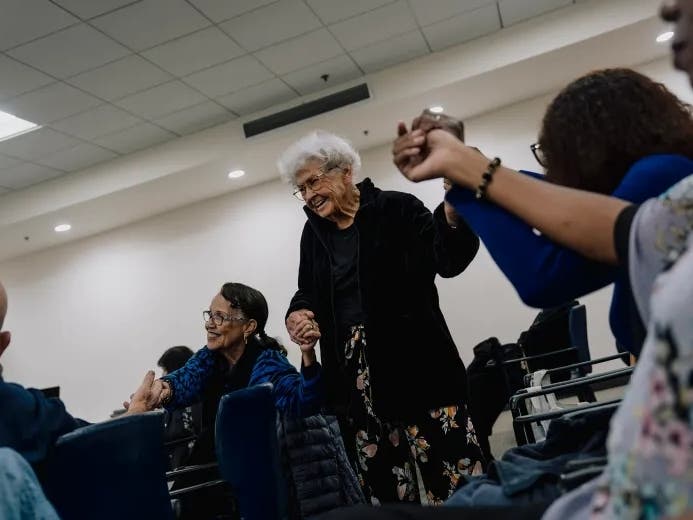 Robinson, 80, Laura Shroder, 89, and Johnnie Devereaux, 86, hold hands and dance as other members sing karaoke at the Culver City Senior Center. 