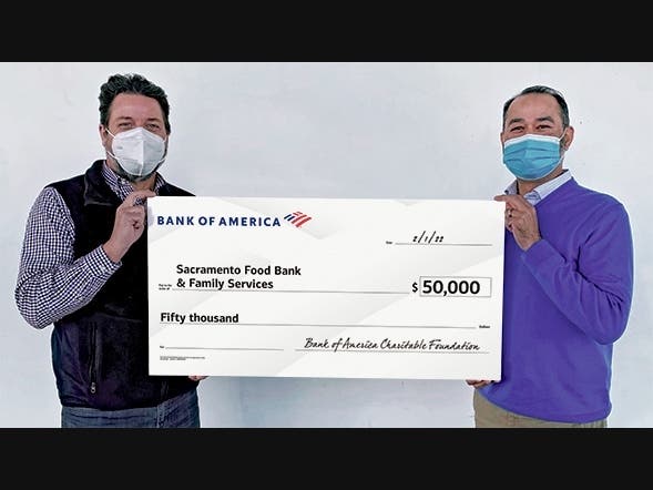 CP Parmar, President, Bank of America Greater Sacramento (right), presents a $50,000 check to Blake Young, President/CEO of Sacramento Food Bank & Family Services. The donation equals 250,000 additional meals for community members in need.