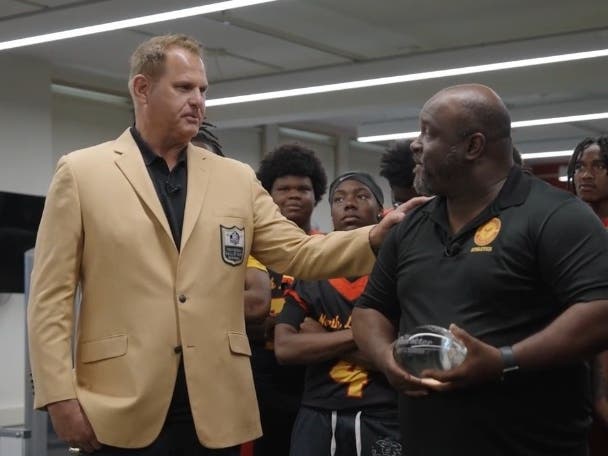 Terrence Redmond, Athletic Director at North Lawndale College Prep, is presented with the July 2026 Award of Character by Pro Football Hall of Famer Jimbo Covert.