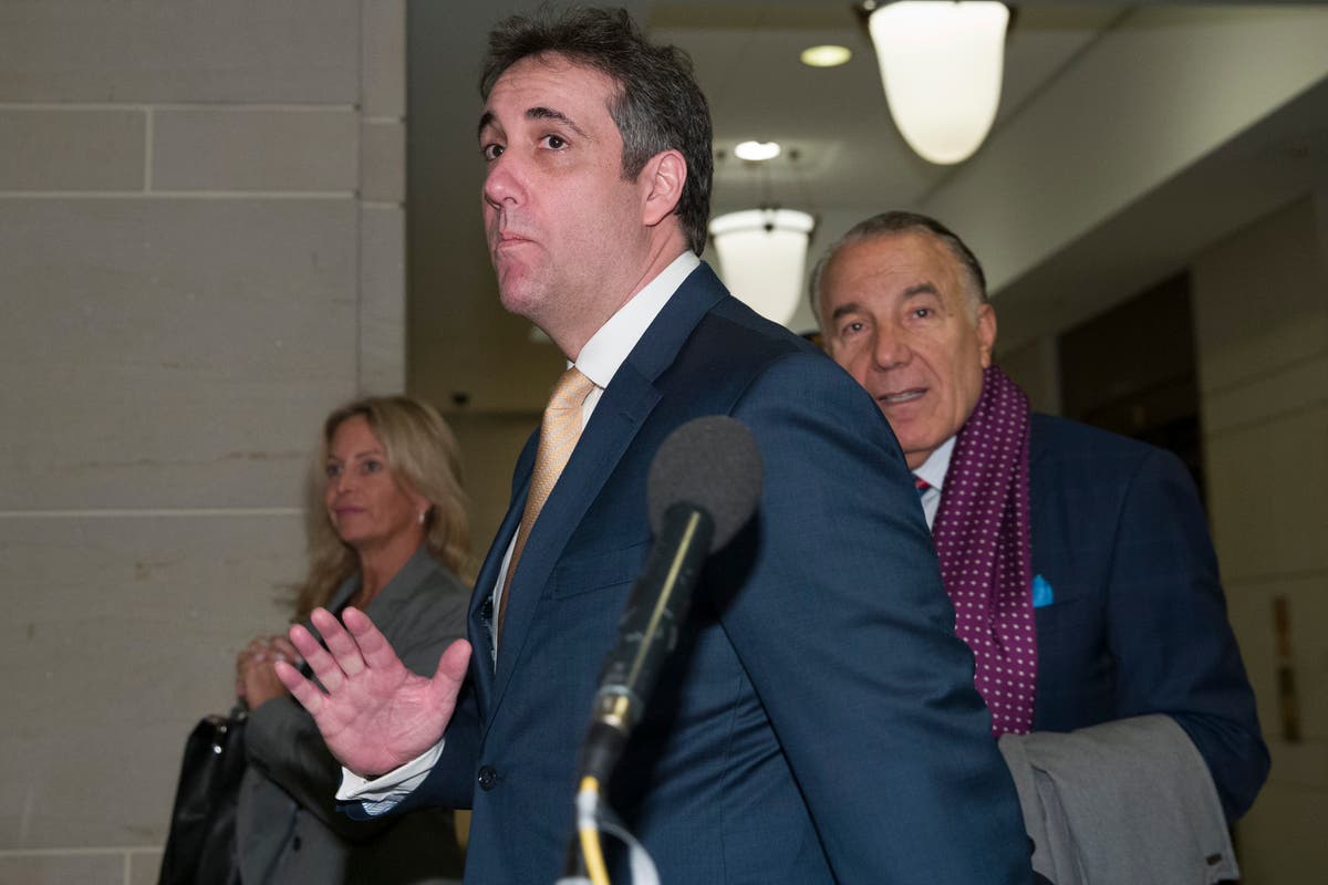 Michael Cohen, center, arrives to testify before a closed-door hearing of the of the House Intelligence Committee.