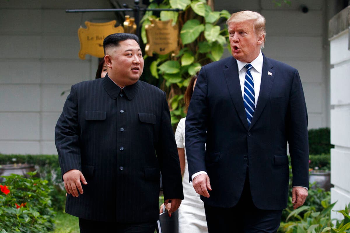President Trump and North Korean leader Kim Jong Un take a walk after their first meeting in Hanoi Thursday.