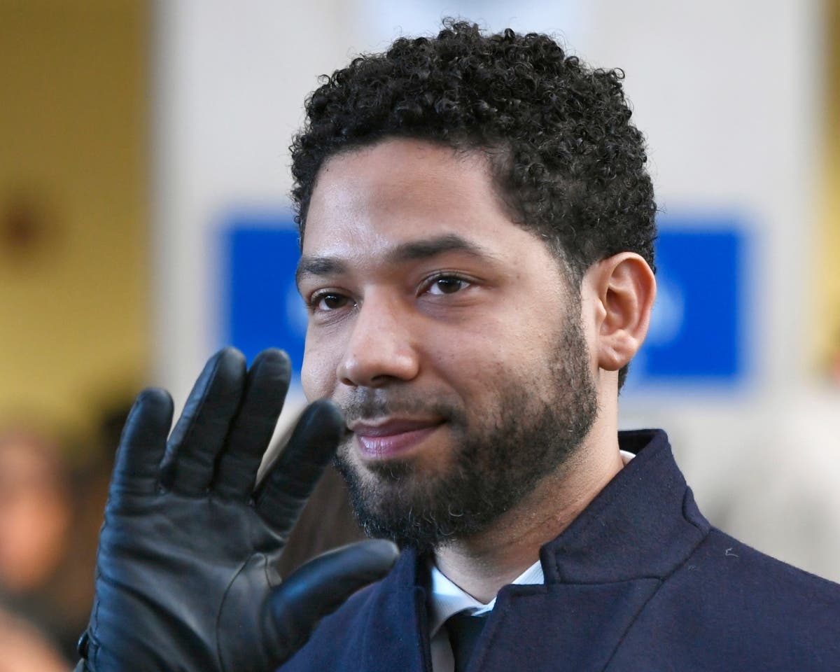 In this March 26, 2019, file photo, actor Jussie Smollett smiles and waves to supporters before leaving court.