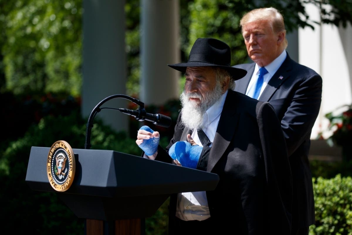 President Donald Trump looks on as Rabbi Yisroel Goldstein, survivor of the Poway synagogue shootings, speaks.