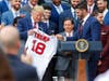 Outfielder J.D. Martinez, right, presents a team jersey to President Donald Trump at the White House Thursday.