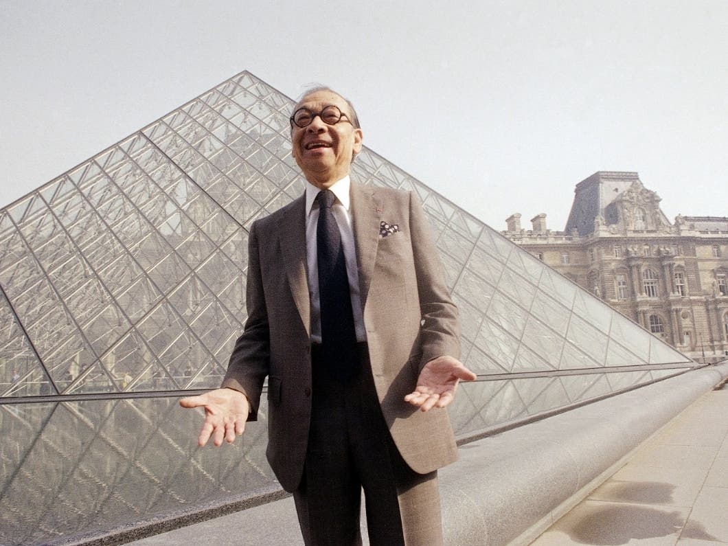 Chinese-American architect I.M. Pei laughs while posing for a portrait in front of the Louvre glass pyramid he designed.