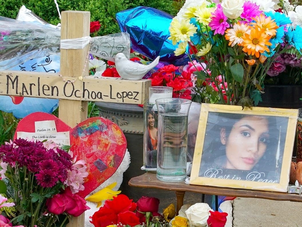 A memorial of flowers, balloons, a cross and photo of Marlen Ochoa-Lopez outside the home where she was murdered.