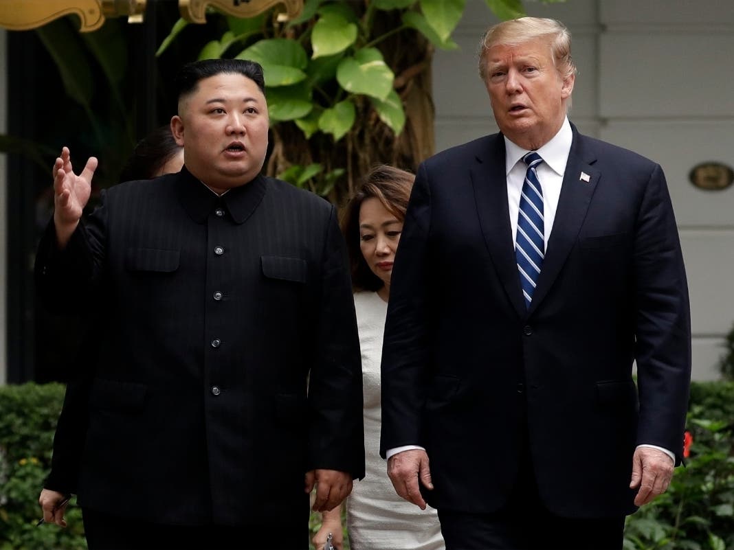 President Donald Trump and North Korean leader Kim Jong Un take a walk after their first meeting.