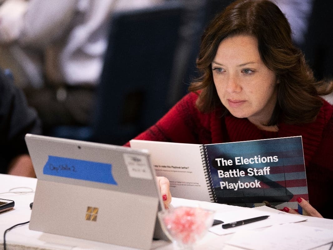 Mandy Vigil, from New Mexico, works during an exercise run by military and national security officials, for state and local election officials to simulate different scenarios for the 2020 elections, in Springfield, Va.
