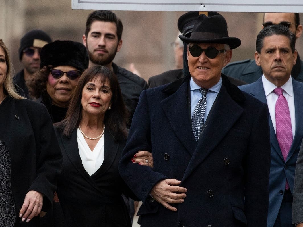 Roger Stone is accompanied by his wife, Nydia Stone (second from left), as he arrives at federal court Thursday in Washington.