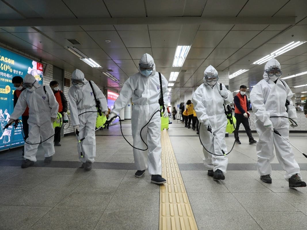 Workers wearing protective gears disinfect as a precaution against the new coronavirus at the subway station in Seoul, South Korea, Wednesday, March 11, 2020.