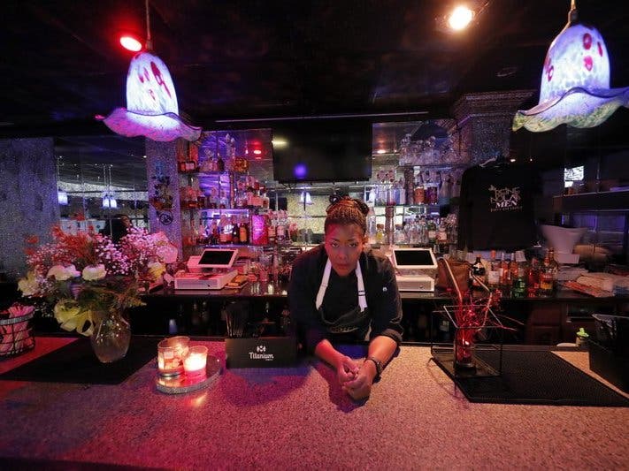 Keisha Henry inside her lounge and catering business in New Orleans. Henry said she lost about $10,000 in revenue last week after three functions she was slated to cater ended up canceling. Henry said she regrettably had to lay off several employees.