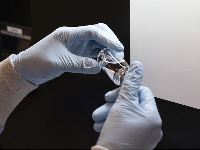 A vial of the investigational drug remdesivir is visually inspected at a Gilead manufacturing site in the United States.