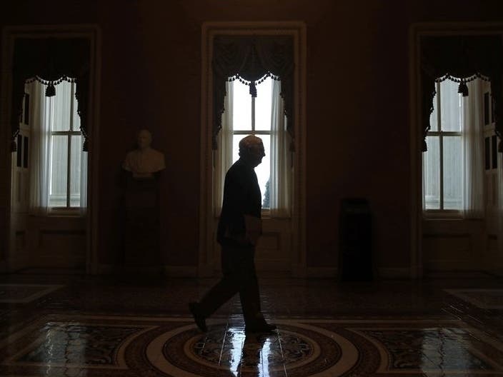Senate Majority Leader Mitch McConnell walks to the Senate chamber on Capitol Hill. The Senate is set to resume Monday. 