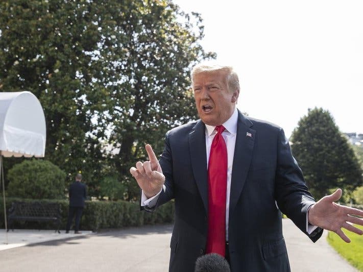 President Donald Trump speaks with reporters before departing on Marine One on the South Lawn of the White House.