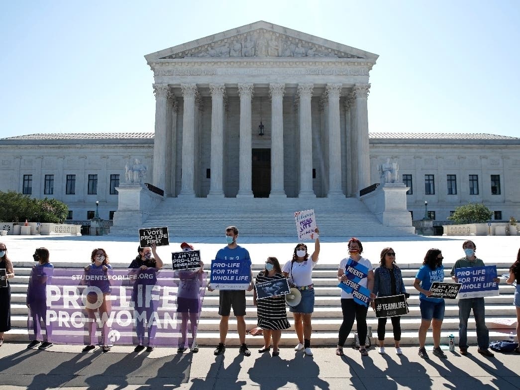Anti-abortion protesters wait outside the Supreme Court for a decision on the Louisiana case. 