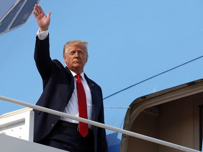 President Donald Trump waves as he boards Air Force One at Andrews Air Force Base, Md. Trump was en route to Mount Rushmore National Memorial.