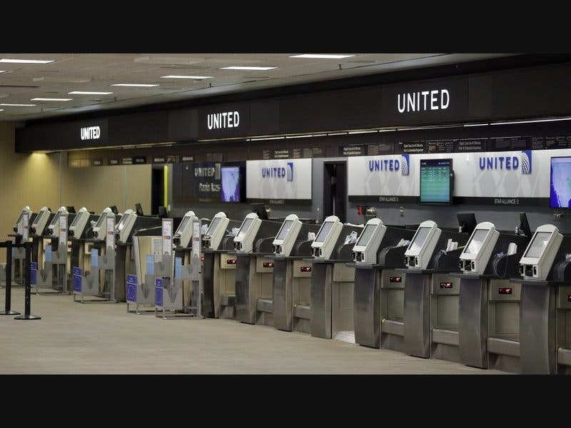 In this file photo, empty United Airlines ticket machines are shown at the Tampa International Airport in Tampa, Fla. 