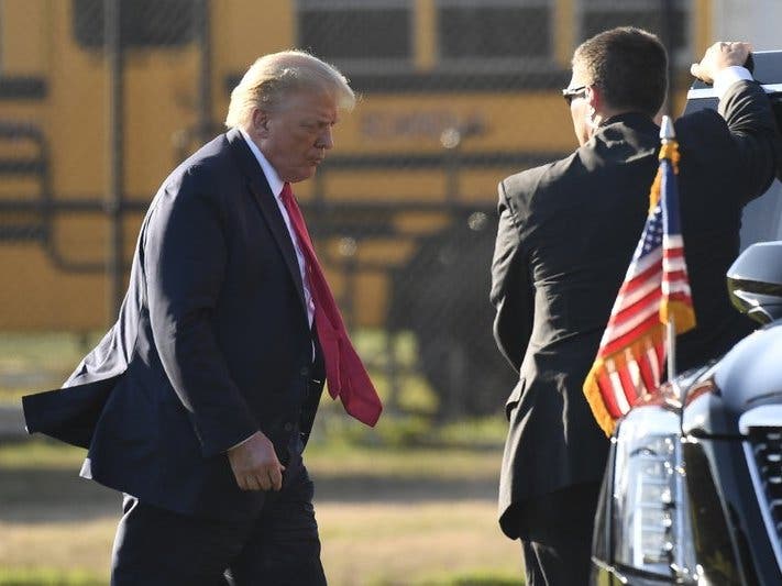 President Donald Trump walks to his car after arriving in Southampton, N.Y., on Marine One. Trump is attending two fundraisers during his visit to the Hamptons.
