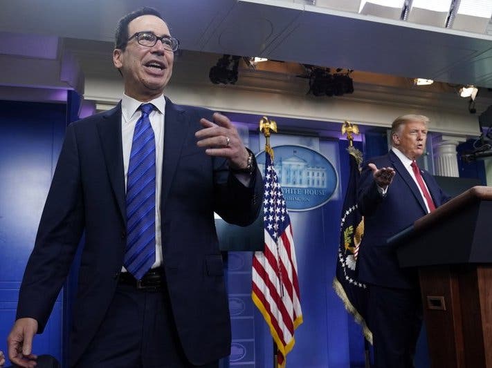 President Donald Trump listens as Treasury Secretary Steven Mnuchin speaks at a news conference in the James Brady Press Briefing Room at the White House. 