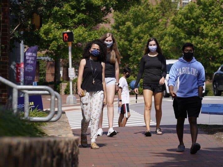 In this file photo, students wear masks on campus at the University of North Carolina in Chapel Hill, N.C. 