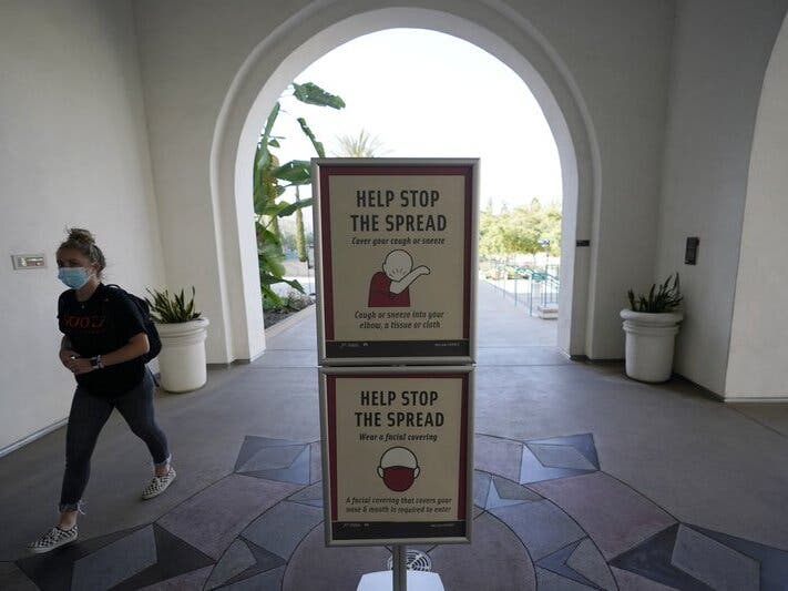 San Diego State University on Wednesday halted in-person classes for a month after dozens of students were infected with the coronavirus. 