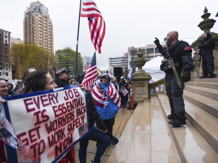 In this April 30, 2020 file photo, protesters rally to denounce Gov. Gretchen Whitmer's stay-home order and business restrictions due to COVID-19.