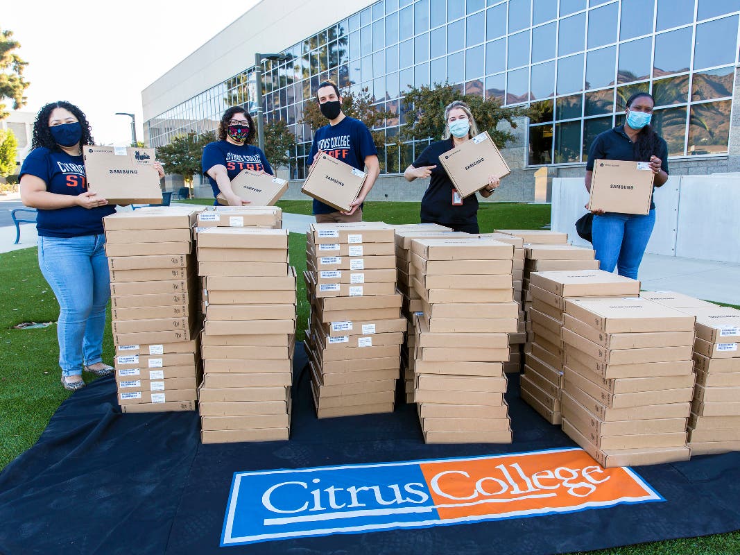 Staff from the Citrus College Student Affairs Division distribute Chromebooks to students during a drive-thru event in October 2020.