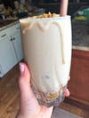 Image shows banana tahini date smoothie. 
