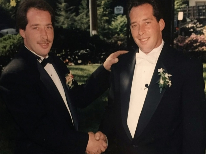 Jeff Kuhn, left, shakes hands with Gordon Kuhn, right, at Gordon's wedding at St Paul's United Methodist Church.
