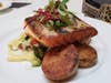 Pan-seared North Atlantic salmon served with roasted potatoes.