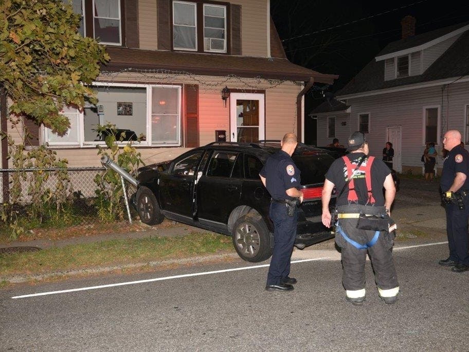 One person was hurt when an SUV crashed into a post, sending a traffic signal through the window of a Hicksville home Tuesday night.