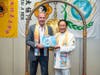 Kenneth Jacobsen, practice professor of law at Temple University, left, is presented with The History of International Day of Conscience by Dr. Hong, which documents important events leading to the UN's designation of April 5 as ICDAY.