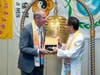 Kenneth Jacobsen, practice professor of law at Temple University, left, is presented with the "Key to the Heart," which symbolizes that conscience is the key that unlocks human kindness, by Dr. Hong. 
