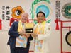 Prof. Massimo Introvigne, managing director of the Center for Studies on New Religions, left, is presented with the “Key to the Heart” by Dr. Hong, Tao-Tze, the leader of Tai Ji Men, after ringing the Bell of World Peace and Love.
