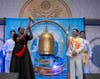 Osinachi Kalu Okoro Egbu, a singer, songwriter, and senior worship leader, left, is posed to ring the Bell of World Peace and Love, as Dr. Hong, Tao-Tze, president of FOWPAL, looks on.