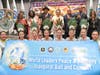 Nancy Sam, vice president of the ECOWAS Confederation Tourism Private Sector, back row, 2nd from left, poses for a group photo with Dr. Hong, Tao-Tze, president of FOWPAL, center, and other peace advocates after ringing the Bell of World Peace and Love.