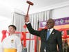 S.E.M. Noel Nelson Messone, Ambassador of Gabon to the U.S., is posed to ring the Bell of World Peace and Love.
