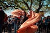 A fan dances with metallic wings at the festival in Long Beach, California.