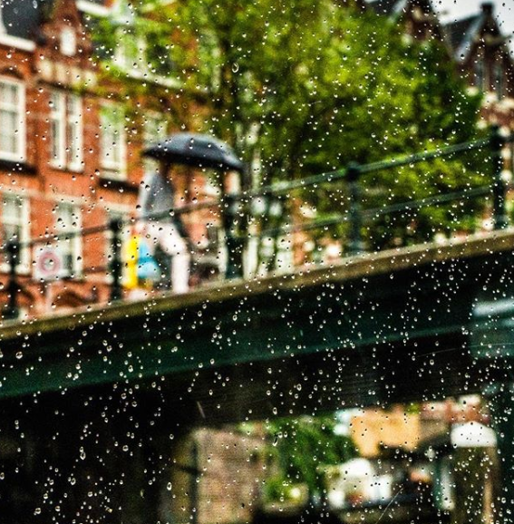 Crossing Bridge in Amsterdam Rain