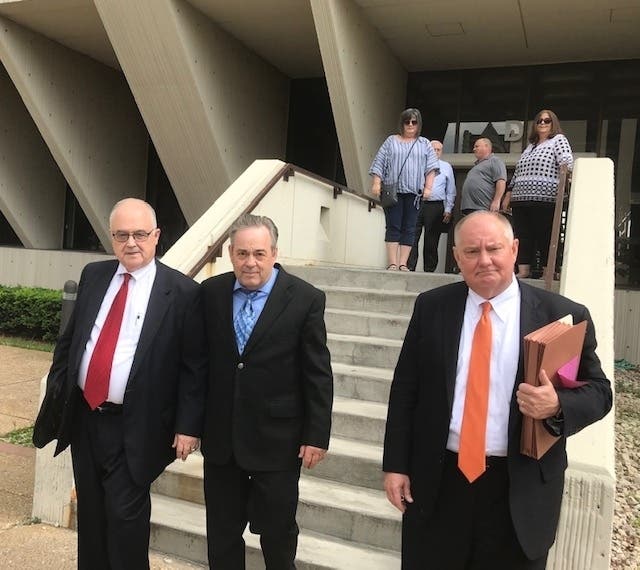 Jim Hess, center, leaves the courthouse with attorneys Jeff Tomczak (right) and Ed Masters.