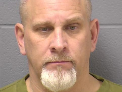 Dean Carbaugh faces four criminal charges in connection with his confrontation with Joliet police, charges show.